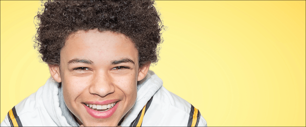 Success Orthodontics - Young man smiling in front of yellow background