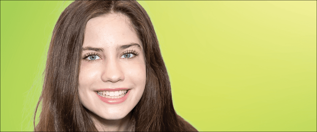 Success Orthodontics - Young woman smiling in front of yellow background