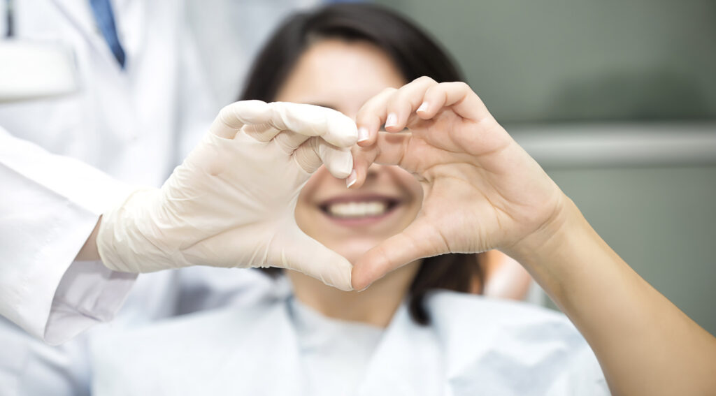 A Doctor And Patient Making A Heart Together With Their Hands