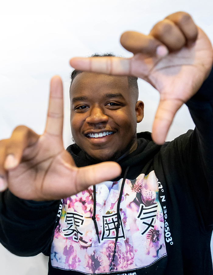 Smiling Man Making Camera Shape With His Hands